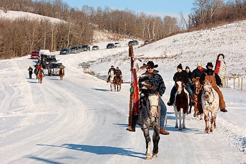 03122024
The Sioux Valley Dakota Nation Unity Riders lead the way to escort 11 bison (often referred to as buffalo in Dakota culture) through Birdtail Sioux First Nation to their new home in an enclosure in Birdtail&#x2019;s valley on Tuesday. The bison, including one white bison, were a gift to Birdtail from Sioux Valley. 
(Tim Smith/The Brandon Sun)