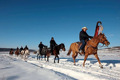 03122024
Sioux Valley Dakota Nation Chief Vince Tacan (R) and The Sioux Valley Dakota Nation Unity Riders lead the way to escort 11 bison (often referred to as buffalo in Dakota culture) through Birdtail Sioux First Nation to their new home in an enclosure in Birdtail&#x2019;s valley on Tuesday. The bison, including one white bison, were a gift to Birdtail from Sioux Valley. 
(Tim Smith/The Brandon Sun)