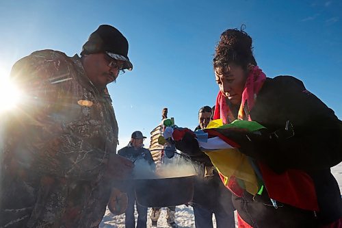 03122024
Community members waiting to see the bison enter their new home at Birdtail Sioux First Nation smudge at the site of the bison enclosure on Tuesday. The bison, including one white bison, were a gift to Birdtail from Sioux Valley. The return of bison to First Nation communities is one of many Indigenous-led endeavors to reclaim their traditions and culture.   (Tim Smith/The Brandon Sun) 
(Tim Smith/The Brandon Sun)