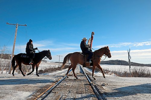 03122024
The Sioux Valley Dakota Nation Unity Riders lead the way to escort 11 bison (often referred to as buffalo in Dakota culture) through Birdtail Sioux First Nation to their new home in an enclosure in Birdtail&#x2019;s valley on Tuesday. The bison, including one white bison, were a gift to Birdtail from Sioux Valley. 
(Tim Smith/The Brandon Sun)