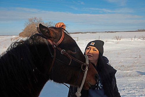 03122024
Cynthia Noel with Sioux Valley Dakota Nation's Unity Riders, pets horse Felix while preparing to escort 11 bison (often referred to as buffalo in Dakota culture) through Birdtail Sioux First Nation to their new home in an enclosure in Birdtail&#x2019;s valley on Tuesday. The bison, including one white bison, are a gift to Birdtail from Sioux Valley. School children, elders, dignitaries and other community members all came out to celebrate the arrival of the bison. The bison, or buffalo, carry important spiritual and cultural significance amongst many First Nations. (Tim Smith/The Brandon Sun)