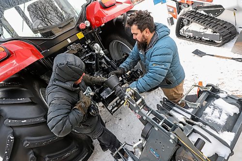 MIKE DEAL / FREE PRESS
Laurie Penton, general manager of Windsor Park Nordic Centre, and Tristan Schneider, groomer at Windsor Park Nordic Centre, attach the trail grooming machine to the tracker Thursday afternoon preparing for the grand opening of the 2.5 km 'primary loop' along the Seine River on Saturday. 
With new equipment and upgrades to the trail, the centre is better prepared for unpredictable weather due to climate change.
241205 - Thursday, December 5, 2024