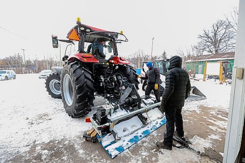 MIKE DEAL / FREE PRESS
Tristan Schneider, groomer at Windsor Park Nordic Centre, volunteer Christian Roe, and Laurie Penton, general manager of Windsor Park Nordic Centre, attach the trail grooming machine to the tracker Thursday afternoon preparing for the grand opening of the 2.5 km 'primary loop' along the Seine River on Saturday. 
With new equipment and upgrades to the trail, the centre is better prepared for unpredictable weather due to climate change.
241205 - Thursday, December 5, 2024