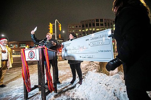 MIKAELA MACKENZIE / FREE PRESS
	
MMF president David Chartrand presents Christmas Cheer Board executive director Shawna Bell with a cheque for fifty thousand dollars (and Infinity Women Secretariat spokesperson Anita Campbell helps hold the novelty cheque on the right) on Thursday, Dec. 5, 2024. 

Winnipeg Free Press 2024