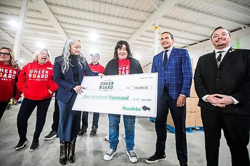 MIKAELA MACKENZIE / FREE PRESS
Families minister Nahanni Fontaine (left), Christmas Cheer Board executive director Shawna Bell, and premier Wab Kinew hold a one hundred thousand dollar cheque for the cheer board from the government of Manitoba on Friday, Dec. 6, 2024.
For Carol story.
Winnipeg Free Press 2024