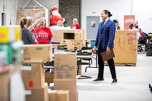 MIKAELA MACKENZIE / FREE PRESS
	
Premier Wab Kinew chats with Christmas Cheer Board volunteers Marcie MacDonald (left), Trudy Mattey, and Kristin Anderson before giving a one hundred thousand dollar cheque to the organization on Friday, Dec. 6, 2024. 

For Carol story.
Winnipeg Free Press 2024