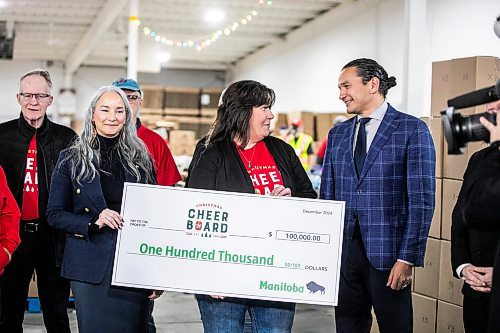 MIKAELA MACKENZIE / FREE PRESS
	
Families minister Nahanni Fontaine (left), Christmas Cheer Board executive director Shawna Bell, and premier Wab Kinew hold a one hundred thousand dollar cheque for the cheer board from the government of Manitoba on Friday, Dec. 6, 2024. 

For Carol story.
Winnipeg Free Press 2024