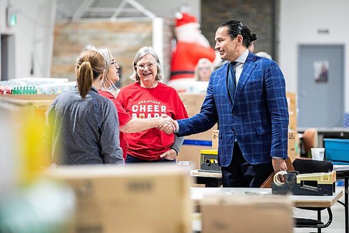 MIKAELA MACKENZIE / FREE PRESS
Premier Wab Kinew shakes hands with Christmas Cheer Board volunteers Marcie MacDonald (left), Trudy Mattey, and Kristin Anderson before giving a one hundred thousand dollar cheque to the organization on Friday, Dec. 6, 2024.
For Carol story.
Winnipeg Free Press 2024