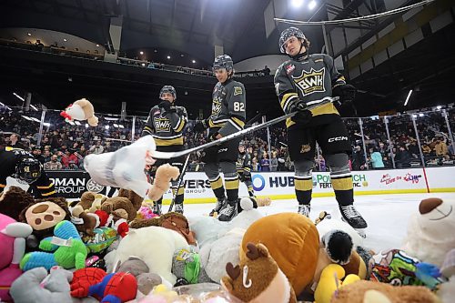 07122024
Volunteers and Brandon Wheat Kings players clean up hundreds of stuffed animals after the Teddy Bear Toss goal  during the first period of WHL action against the Prince Albert Raiders at Westoba Place on Saturday evening. The stuffed animals and other items are collected for Brandon-Westman Christmas Cheer. 
(Tim Smith/The Brandon Sun)