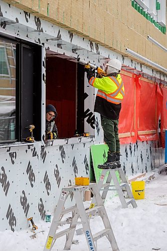 MIKE DEAL / FREE PRESS
Construction workers install a new window at Gordon Bell High School Monday.
Terry Duguid, Parliamentary Secretary to the Prime Minister and Special Advisor for Water, along with Gordon Bell High School principal, Vinh Huynh, speak during an announcement, at the school Monday, that the federal government is investing $4.8 million in funding through the Green Infrastructure: Energy Efficient Buildings program to complete a retrofit that will create a comfortable, climate-resilient school environment with reduced operating costs and lower greenhouse gas emissions.
Reporter: Maggie Macintosh
241209 - Monday, December 09, 2024.