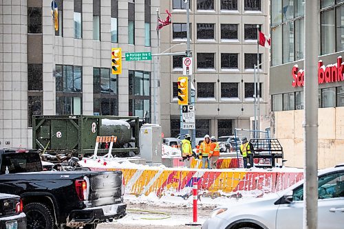 MIKAELA MACKENZIE / FREE PRESS
	
Construction workers at the south west corner of Portage and Main as the concrete barrier starts to get taken down on Tuesday, Dec. 10, 2024.


Winnipeg Free Press 2024