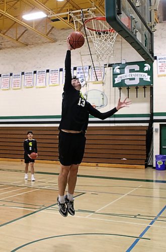 Eric Muller rises to dunk during Monday's shoot around. (Thomas Friesen/The Brandon Sun)