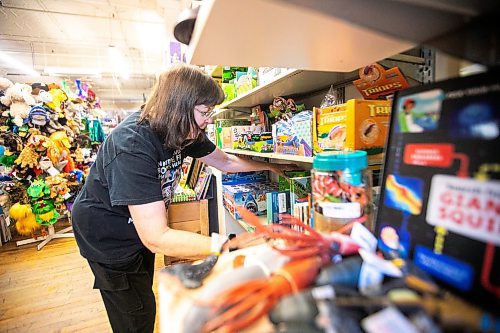 MIKAELA MACKENZIE / FREE PRESS
	
Sue Fonseca, who has worked at Toad Hall Toys for 20 years, shelves stock at the store on Wednesday, Dec. 11, 2024. The store is scrambling to adjust the computerized inventory management system ahead of the upcoming GST holiday.

For Scott Billeck story.
Winnipeg Free Press 2024