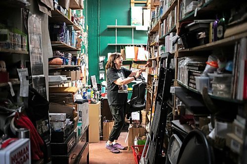 MIKAELA MACKENZIE / FREE PRESS
	
Sue Fonseca, who has worked at Toad Hall Toys for 20 years, looks through stock in the back rooom at the store on Wednesday, Dec. 11, 2024. The store is scrambling to adjust the computerized inventory management system ahead of the upcoming GST holiday.

For Scott Billeck story.
Winnipeg Free Press 2024