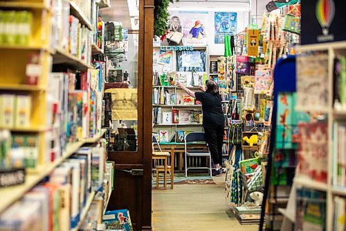 MIKAELA MACKENZIE / FREE PRESS
	
Sue Fonseca, book Toad, organizes and arranges the book selection at Toad Hall Toys on Wednesday, Dec. 11, 2024. The store is scrambling to adjust the computerized inventory management system ahead of the upcoming GST holiday.

For Scott Billeck story.
Winnipeg Free Press 2024