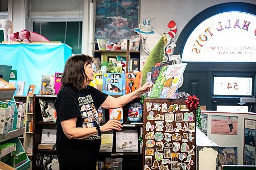 MIKAELA MACKENZIE / FREE PRESS
	
Sue Fonseca, book Toad, organizes and arranges the book selection at Toad Hall Toys on Wednesday, Dec. 11, 2024. The store is scrambling to adjust the computerized inventory management system ahead of the upcoming GST holiday.

For Scott Billeck story.
Winnipeg Free Press 2024