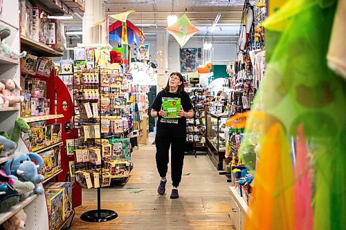 MIKAELA MACKENZIE / FREE PRESS
	
Sue Fonseca, who has worked at Toad Hall Toys for 20 years, shelves stock at the store on Wednesday, Dec. 11, 2024. The store is scrambling to adjust the computerized inventory management system ahead of the upcoming GST holiday.

For Scott Billeck story.
Winnipeg Free Press 2024