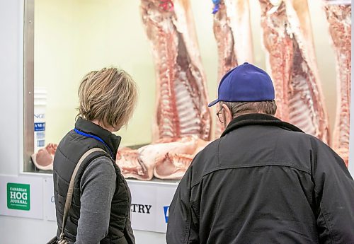 BROOK JONES/FREE PRESS
Cam Ives from Sollio Agriculture (left) and Harold Waldner from Grand Colony look at hog carcasses displayed at the Pork Quality Competition during the Prairie Livestock Expo at the Victoria Inn in Winnipeg, Man., Wednesday, Dec. 11, 2024.