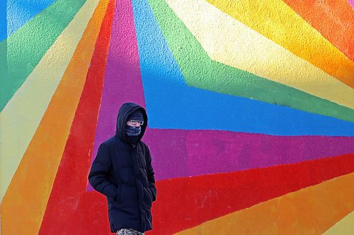 12122024
A bundled up pedestrian walks past the Sun Spectrums mural by artist James Culleton on Rosser Avenue in Brandon on a frigid Thursday morning. (Tim Smith/The Brandon Sun)