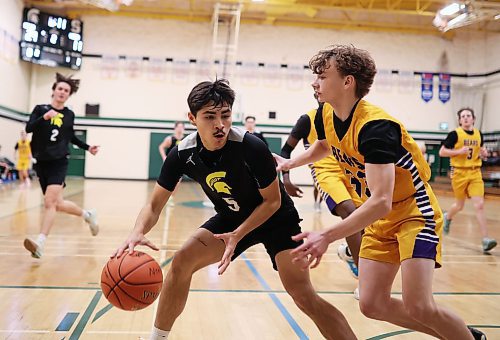 12122024
Kingston Thomas #5 of the Neelin Spartans looks for a way  around Preston Studer #33 of the Virden Golden Bears during the opening match of the Brandon Sun Spartan Invitational varsity basketball tournament at &#xc9;cole Secondaire Neelin High School on Thursday.    (Tim Smith/The Brandon Sun)