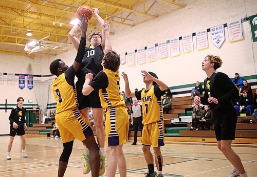 12122024
Ethan Olson #10 of the Neelin Spartans leaps for a shot on net during the opening match against the Virden Golden Bears in the Brandon Sun Spartan Invitational varsity basketball tournament at &#xc9;cole Secondaire Neelin High School on Thursday.    (Tim Smith/The Brandon Sun)