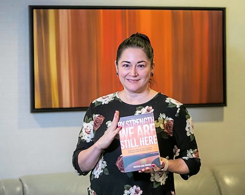 BROOK JONES/FREE PRESS
Crystal Gail Fraser who is an associate professor in history and native studies at the University of Alberta in Edmonton, Alta., holds a copy of By Strength We Are Still Here which she wrote and was published by the University of Manitoba Press. Fraser was pictured in the lobby of the Hilton Winnipeg Airport Suites in Winnipeg, Man., Thursday, Dec. 12, 2024.