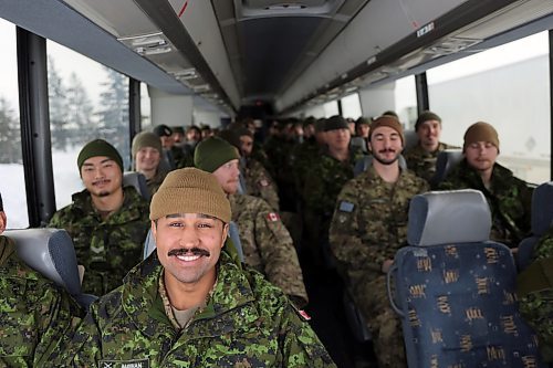 Cpl. Aaron Maclennan sits at the front of one bus leaving CFB Shilo on Friday, Dec. 13. About 175 soldiers deployed from the base near Brandon on a bus ride to Winnipeg, where they will fly to Latvia as part of Operation Reassurance. The operation trains NATO allies and deters aggression in the area through military presence. It is a six month deployment for soldiers from Shilo. (Connor McDowell/Brandon Sun)