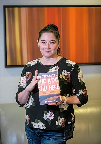 BROOK JONES/FREE PRESS
Crystal Gail Fraser who is an associate professor in history and native studies at the University of Alberta in Edmonton, Alta., holds a copy of By Strength We Are Still Here which she wrote and was published by the University of Manitoba Press. Fraser was pictured in the lobby of the Hilton Winnipeg Airport Suites in Winnipeg, Man., Thursday, Dec. 12, 2024.