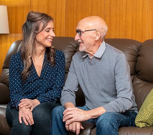 BROOK JONES/FREE PRESS
Free Press columnist Sabrina Carnevale, 43, (left) and her dad Pasquale Carnevale, 75, smile at each other during a visit at her parents' home in West St. Paul, Man., Thursday, Dec. 12, 2024. Pasquale is recovering after having a tanscatheter aortic valve implantation procedure done at St. Boniface Hopital in Winnipeg, Man., Tuesday, Nov. 26, 2024.