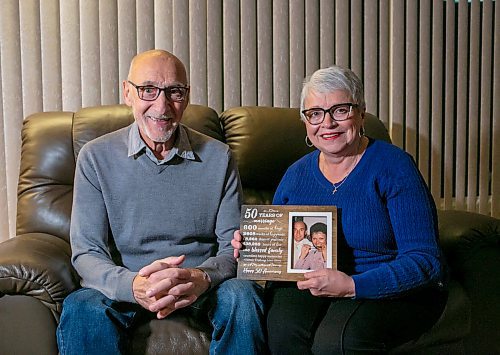 BROOK JONES/FREE PRESS
Free Press columnist Sabrina Carnevale's dad Pasquale Carnevale, 75, (left) and her mom Gina Carnevale, 71, look at a momento from their 50 wedding anniversary, which features a photograph of them when they were in their 40s. Pasquale and Gina were pictured at their home in West St. Paul, Man., Thursday, Dec. 12, 2024. Pasquale is recovering after having a tanscatheter aortic valve implantation procedure done at St. Boniface Hopital in Winnipeg, Man., Tuesday, Nov. 26, 2024.