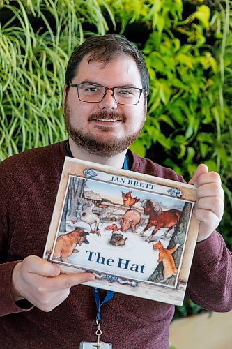 MIKE DEAL / FREE PRESS
Librarian Eric Fontaine holding his favourite festive read The Hat by Jan Brett at the Transcona Public Library.
Reporter: AV Kitching
241211 - Wednesday, December 11, 2024.
