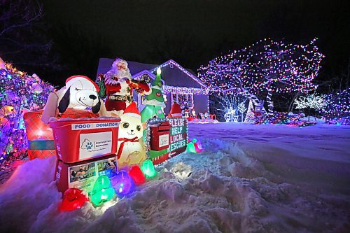 A brightly-lit home at 522 22nd Street on Monday evening sports a food and monetary donation display for One At A Time Rescue, a Brandon-based organization that focuses primarily on orphaned animals. Owner Patrick Stewart has worked since November to ready the holiday light display for the fundraiser.  (Matt Goerzen/The Brandon Sun)