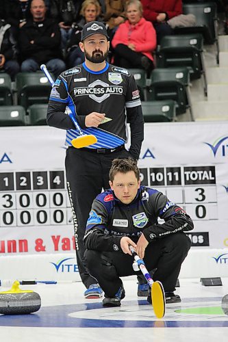 Skip Reid Carruthers of the West St. Paul Curling Club looks over the shoulder of a crouched Jason Gunnlaugson of the Granite Curling Club the last time a Viterra Championship was held in Stride Place in Portage la Prairie back in 2017. (Nathan Liewicki/The Brandon Sun)