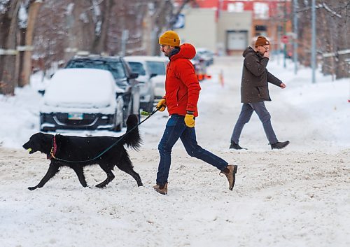 MIKE DEAL / FREE PRESS
Pedestrians navigate the snow covered street along Westminster Avenue Tuesday afternoon. The city will conduct a full residential street plow starting Wednesday evening.
Reporter: Malak Abas
241217 - Tuesday, December 17, 2024.