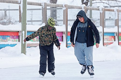 Ayden Ducharme (right) helps friend Philip Fehintola (left) learn to ice skate at the Central Community Centre in Brandon on Tuesday afternoon. (Tim Smith/The Brandon Sun)