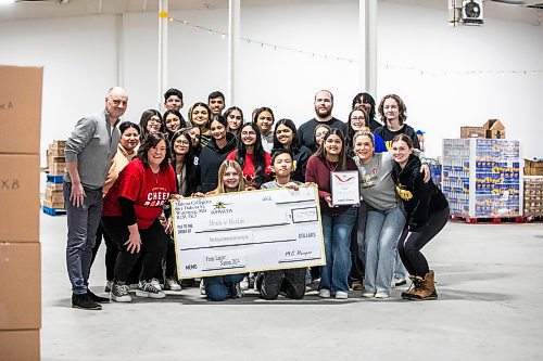 MIKAELA MACKENZIE / FREE PRESS
	
Dakota Collegiate grade 10-12 students present a cheque to Cheer Board executive director Shawna Bell and Paul Samyn as part of Miracle on Mountain on Tuesday, Dec. 17, 2024.


Winnipeg Free Press 2024