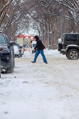 MIKE DEAL / FREE PRESS
Pedestrians navigate the snow covered street along Westminster Avenue Tuesday afternoon. The city will conduct a full residential street plow starting Wednesday evening.
Reporter: Malak Abas
241217 - Tuesday, December 17, 2024.