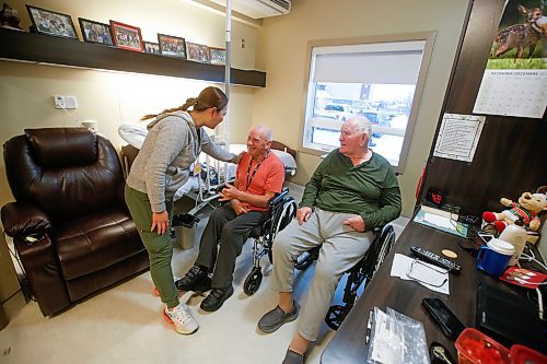 JOHN WOODS / FREE PRESS
Cherry Ponc, nurse, is photographed with residents Wilhelm Funk, right, and David Sawatzky  at the Heritage Life Personal Care Home Tuesday, December 17, 2024. Rural care homes often face a lack of capacity - either short beds, short staff or both.

Reporter: gabby