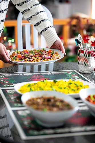 MIKAELA MACKENZIE / FREE PRESS
	
Chickpea salad (back), lentils with mushrooms (front left), and Manchurian soya (front right), served with basmati rice, on Monday, Dec. 9, 2024. These are all options for plant-based proteins in holiday meals.

For Romona story.
Winnipeg Free Press 2024