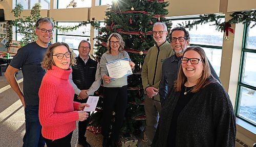 Brenda Tonn with Age Friendly Manitoba (centre), presents a certificate for $10,000 to representatives of senior-friendly organizations in Brandon, a local business and the Riverbank Discovery Centre. From left, Grant Hamilton, Bike Brandon, Nancy McPherson, Age Friendly Brandon, Dan Robertson, Riverbank Discovery Centre board member, Dean Hammond, executive director, Riverbank Discovery Centre, Cam Wirch, A&L Cycle, and Eleysha Klaassen, executive director, Seniors for Seniors. (Michele McDougall/The Brandon Sun)