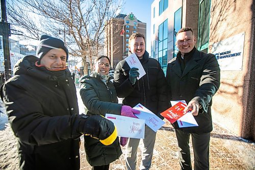 MIKAELA MACKENZIE / FREE PRESS
	
Steve Bagel (left), Elena Anciro, Matthew Samyn, and Brandon Boone get ready to hand-deliver a thank-you note to IG Wealth Management on Wednesday, Dec. 18, 2024.

For Koralee story.
Winnipeg Free Press 2024