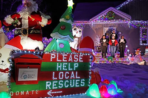 Singers with the Neelin Chamber Choir and Neelin Simple Green perform Christmas carols outside Patrick Stewart’s brightly decorated home on the 500 block of 22nd Street in Brandon on a cold Wednesday evening. Stewart is collecting donations of food or cash for One At A Time Rescue, a local organization for orphaned animals. (Tim Smith/The Brandon Sun)