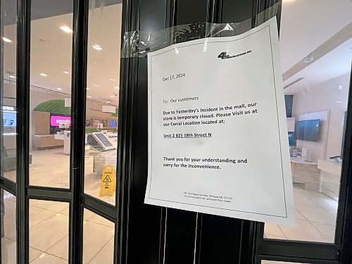 A sign attached to the closed entrance of the Telus store front at the Shoppers Mall on Wednesday afternoon directs shoppers to the company's Corral Centre location on 18th Street, following an incident on Monday morning that prompted the mall's evacuation. (Matt Goerzen/The Brandon Sun)