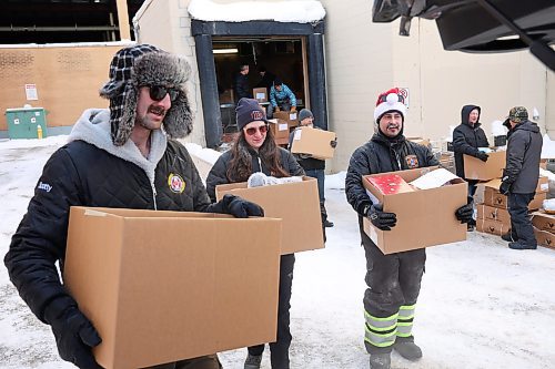 17122024
Scott Ryan, Kaitlyn May and Gage Wood with Brandon Fire &amp; Emergency Services help load Christmas hampers into waiting vehicles outside Brandon-Westman Christmas Cheer on 7th Street in Brandon on Wednesday. Volunteers worked all day and evening Wednesday to prep and send out Christmas hampers to families in need for the holidays. Volunteers will be back at it today to deliver the remainder of the hampers.
(Tim Smith/The Brandon Sun)