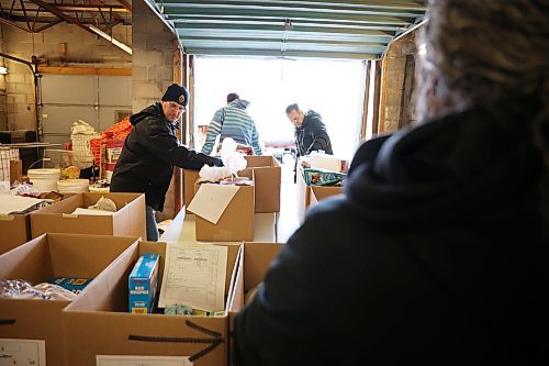 17122024
Volunteers help organize and move Christmas hampers through the warehouse to waiting vehicles outside Brandon-Westman Christmas Cheer on 7th Street in Brandon on Wednesday. Volunteers worked all day and evening Wednesday to prep and send out Christmas hampers to families in need for the holidays. Volunteers will be back at it today to deliver the remainder of the hampers.
(Tim Smith/The Brandon Sun)