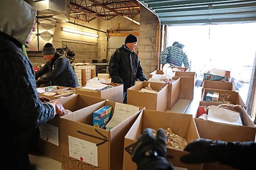 17122024
Volunteers help organize and move Christmas hampers through the warehouse to waiting vehicles outside Brandon-Westman Christmas Cheer on 7th Street in Brandon on Wednesday. Volunteers worked all day and evening Wednesday to prep and send out Christmas hampers to families in need for the holidays. Volunteers will be back at it today to deliver the remainder of the hampers.
(Tim Smith/The Brandon Sun)