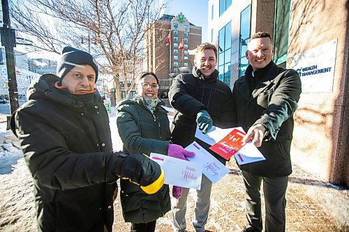 MIKAELA MACKENZIE / FREE PRESS
	
Steve Bagel (left), Elena Anciro, Matthew Samyn, and Brandon Boone get ready to hand-deliver a thank-you note to IG Wealth Management on Wednesday, Dec. 18, 2024.

For Koralee story.
Winnipeg Free Press 2024