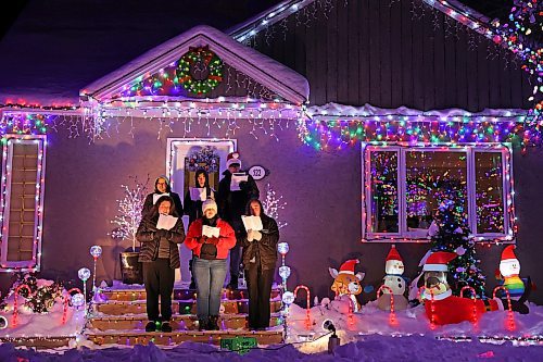 18122024
Singers with the Neelin Chamber Choir and Neelin Simple Green perform Christmas carols outside Patrick Stewart&#x2019;s brightly decorated home in the 500 block of 22nd Street in Brandon on a cold Wednesday evening. Stewart is collecting donations of food or cash for One At A Time Rescue, a local organization for orphaned animals.
(Tim Smith/The Brandon Sun)