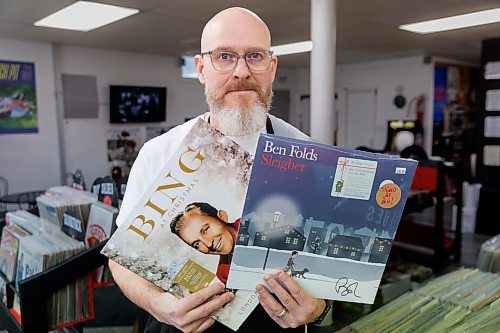 MIKE DEAL / FREE PRESS
Ryan French, co-owner with his dad of Frenchie’s Records & Coffee, shows off seasonal vinyl by Bing Crosby and Ben Folds.