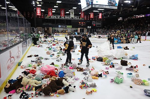 07122024
Volunteers and Brandon Wheat Kings players clean up hundreds of stuffed animals after the Teddy Bear Toss goal  during the first period of WHL action against the Prince Albert Raiders at Westoba Place on Saturday evening. The stuffed animals and other items are collected for Brandon-Westman Christmas Cheer. 
(Tim Smith/The Brandon Sun)